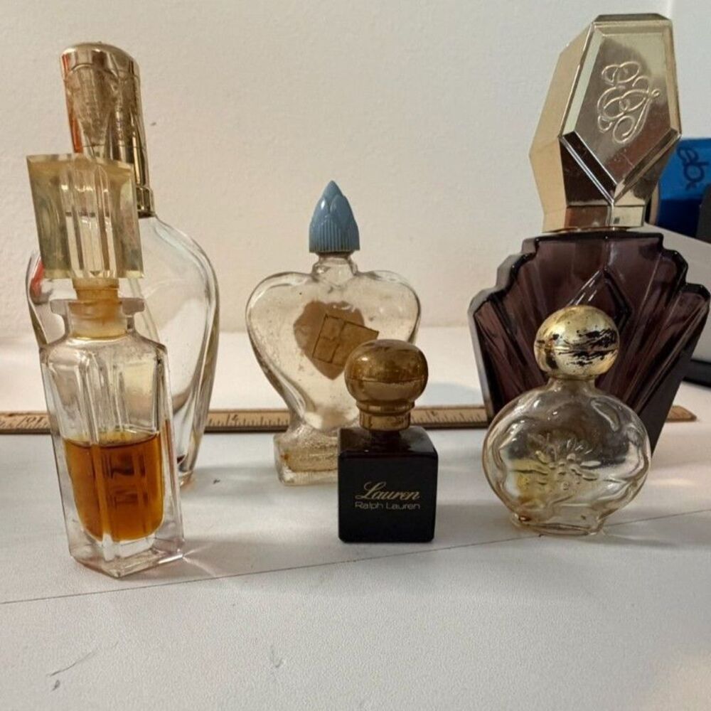 collection of vtg designer perfume bottles including passion